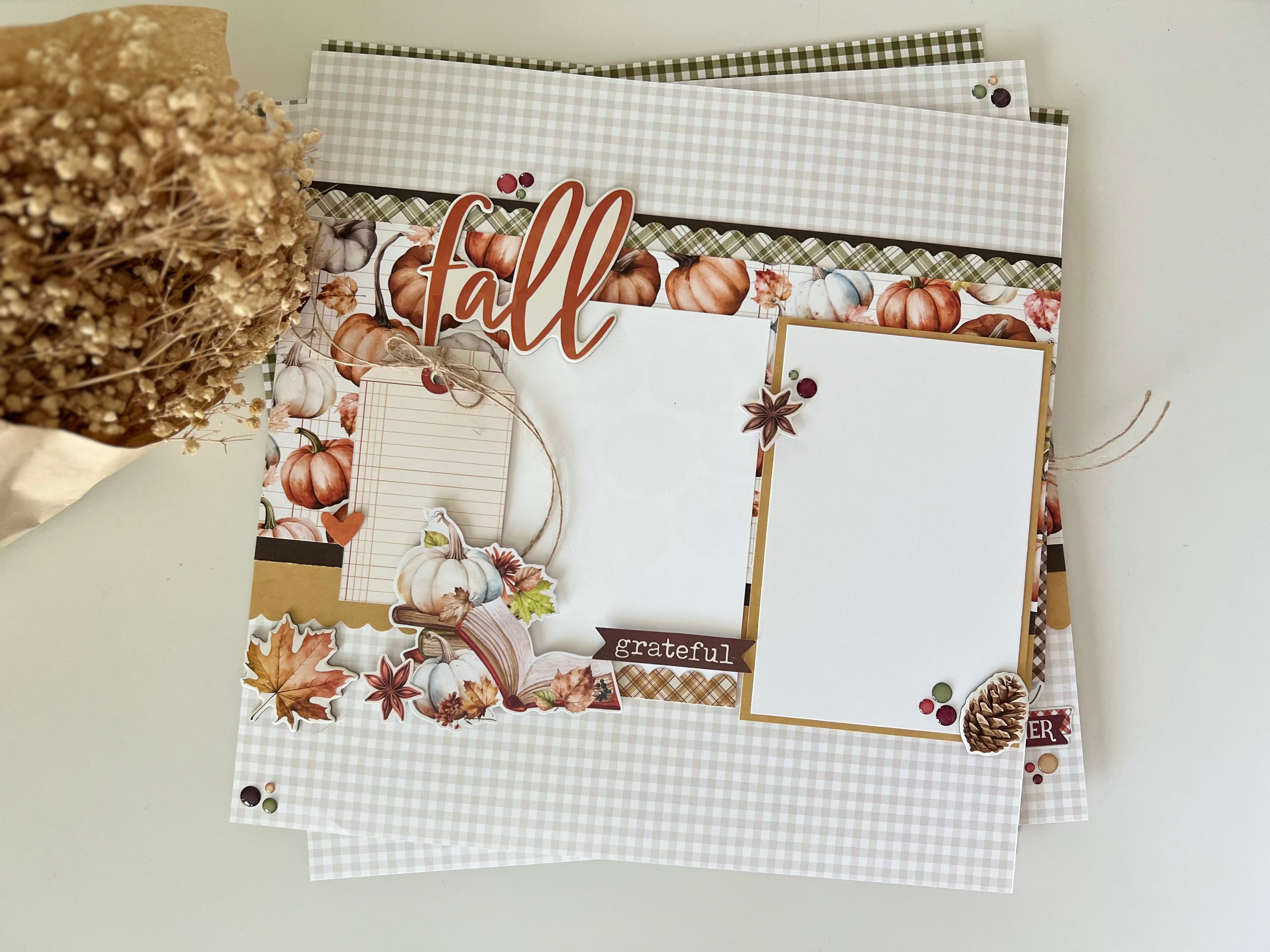 Decorative paper with autumnal designs and a gold flower on a light background